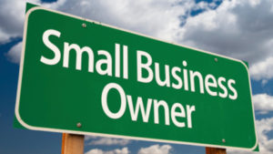 Small Business Owner Green Road Sign and Clouds